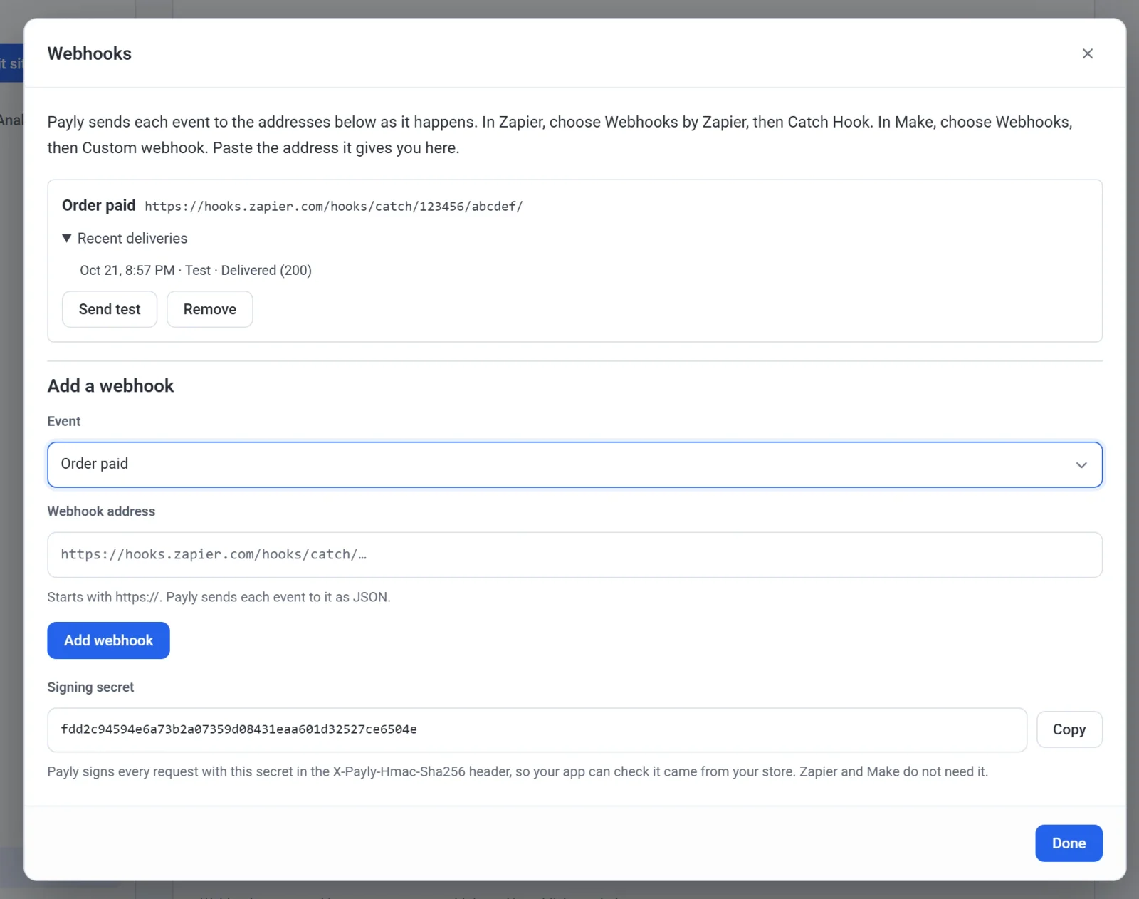 The Webhooks pop-up with one webhook for Order paid and its Zapier address. Its recent deliveries show a test that was delivered. Below are the Add a webhook form and the store's signing secret with a Copy button