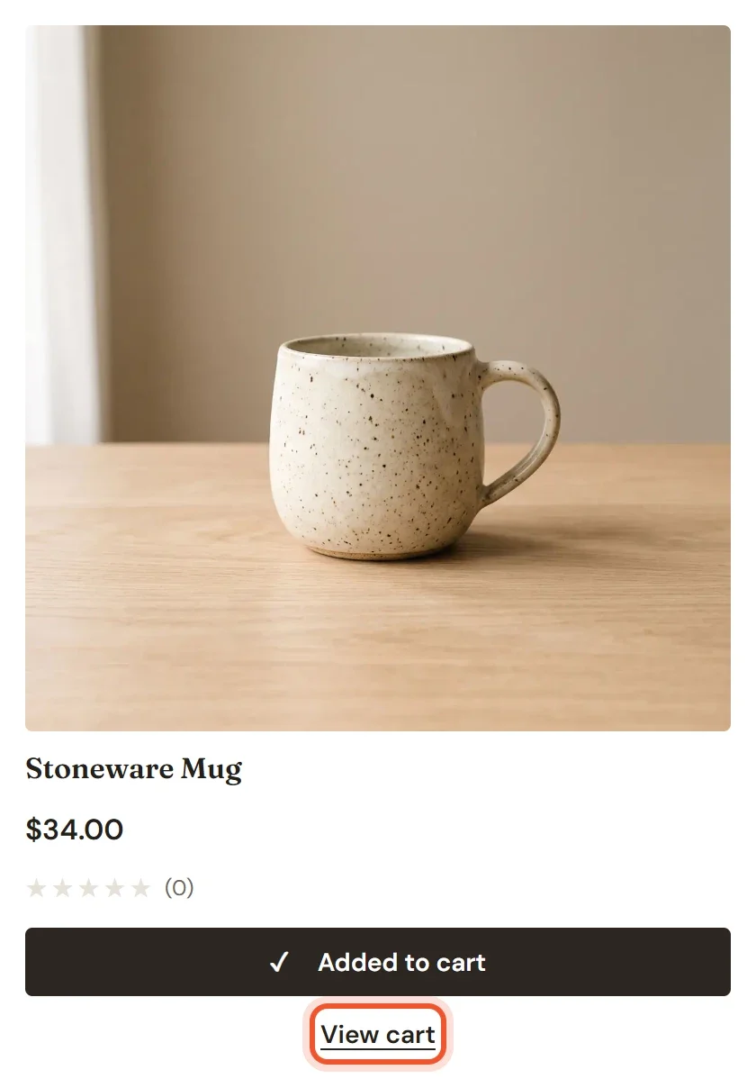 A product card for the Stoneware Mug with the button reading Added to cart and a highlighted View cart link below it
