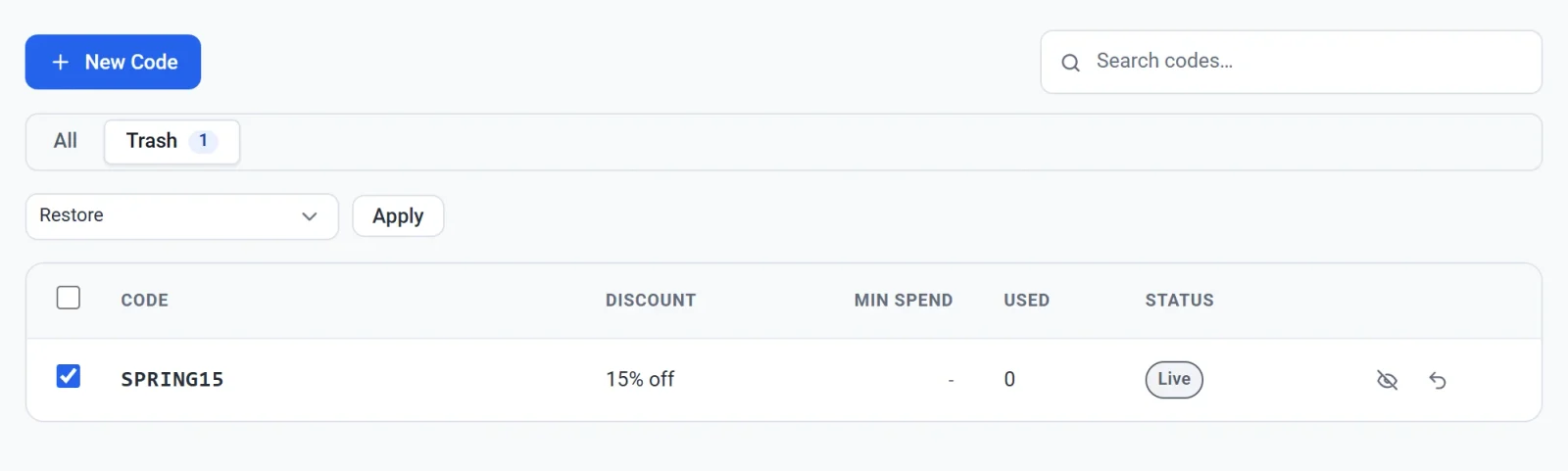 The Trash tab of the Discounts list with one code ticked and Restore chosen in the Bulk actions menu